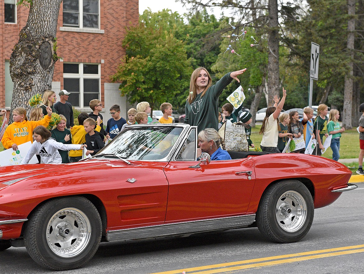 Candy is thrown from a Corvette driving in the 2022 Whitefish Homecoming Parade. (Whitney England/Whitefish Pilot)