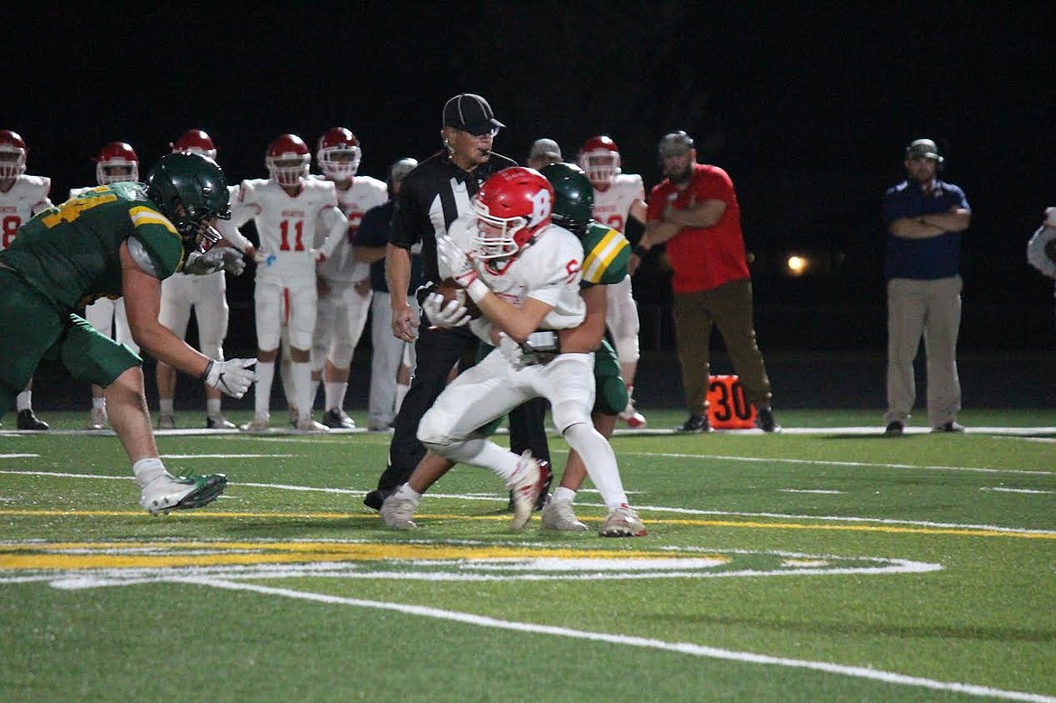 The Quincy defense wraps up a Brewster running back during the Jacks' 34-6 win over the Bears on Friday.