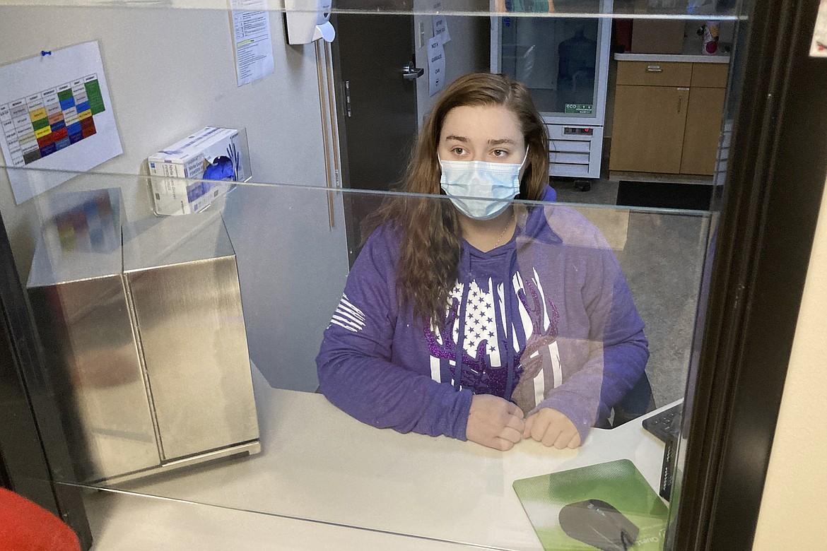 Vanessa Caudel, a nurse, sits at her work station in the Great Circle treatment center on Feb. 24, 2022, in Salem, Ore., where she provides doses of methadone, which can relieve the "dope sick" symptoms a person in opioid withdrawal experiences. Almost two years after Oregonians voted to decriminalize drugs and dedicate hundreds of millions of dollars to treatment services, the pioneering effort has been struggling to show progress. (AP Photo/Andrew Selsky, File)