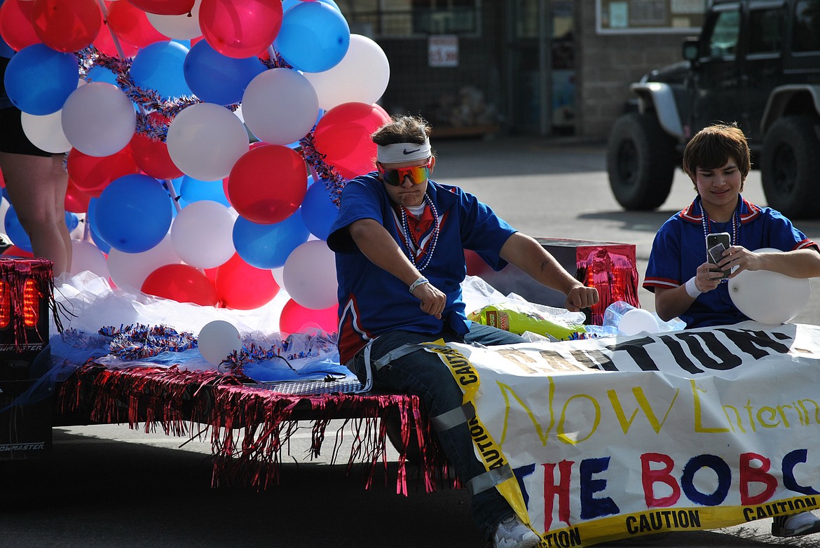 Trevor Wolff busts a move, while Isaac Miller captures the moment upon the Junior float. (Amy Quinlivan/Mineral Independent)