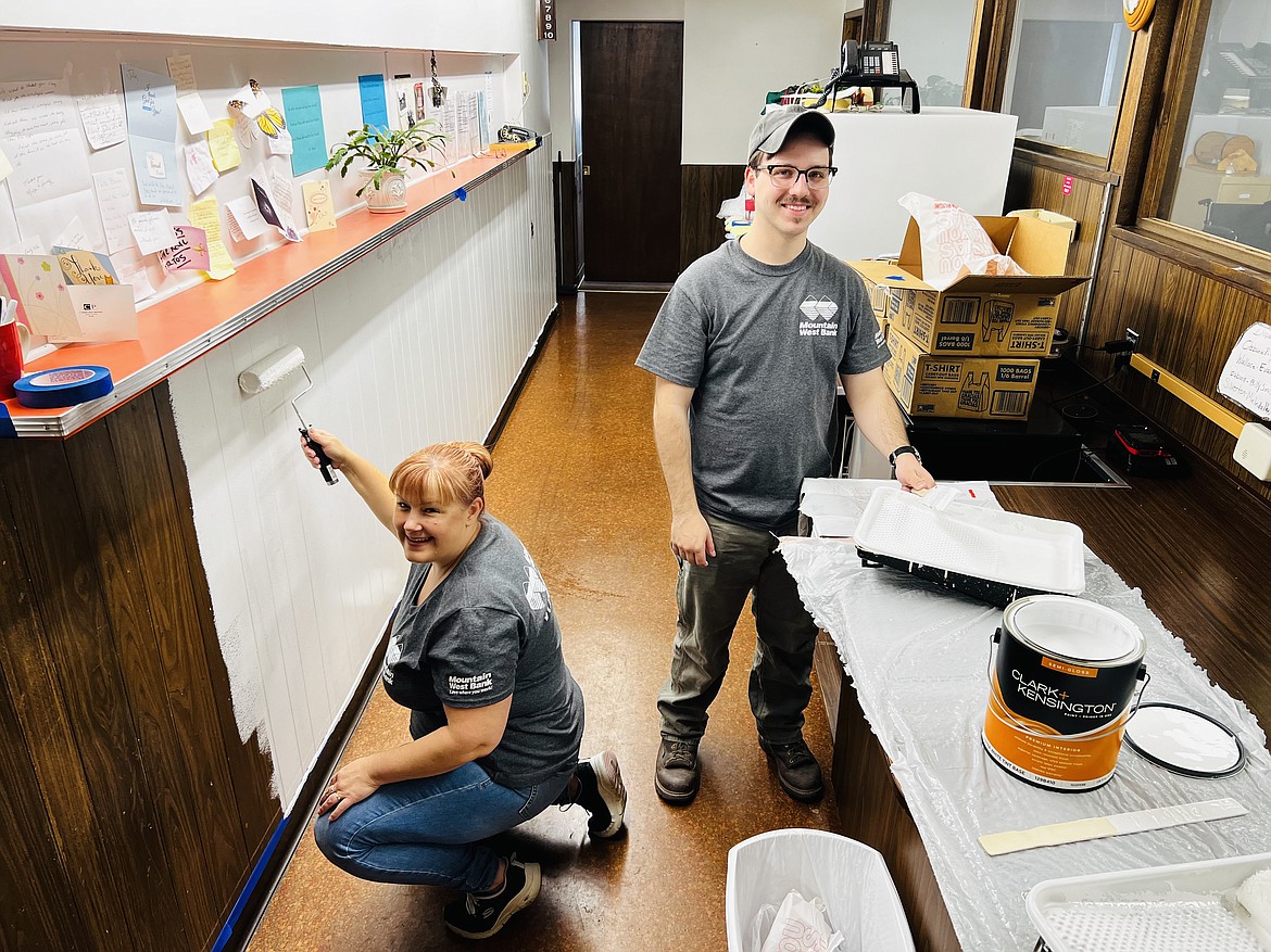 Mountain West Bank employees Tanya Picker and Jeremy Bullen take a second from their busy day painting to pose for a picture during their Day of Caring service adventure at the Silver Valley Meals on Wheels office in Osburn.
