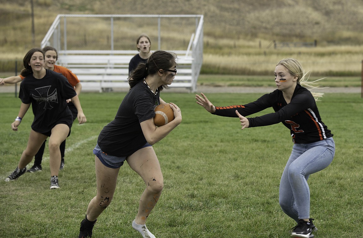 Jaelyn Carr blocks Kay Lynn Boes during the homecoming powder puff game. (Tracy Scott/Valley Press)