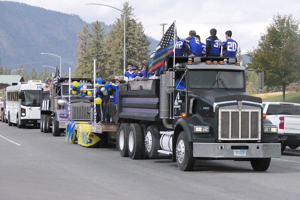 Members of the Blue Hawks football team pack the box of a large dump truck during Saturday's Thompson Falls High Homecoming parade.  (Chuck Bandel/VP-MI)