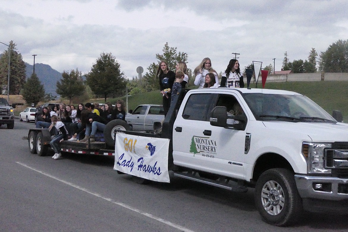 Thompson Falls girl athletes ride on the back of a float during the annual homecoming parade Saturday in downtown Thompson Falls. (Chuck Bandel/VP-MI)