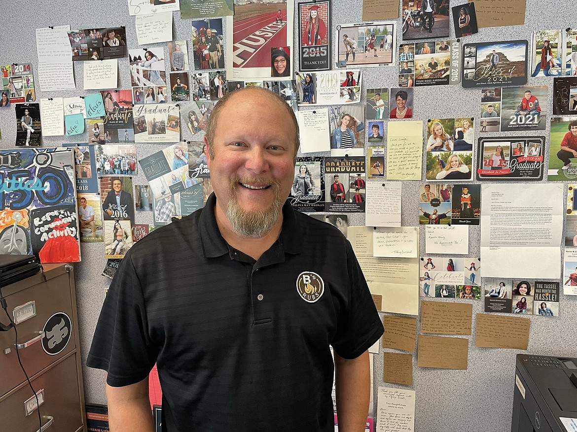 Brian Lumsden, owner of B’s Rubs, in his classroom at Othello High School, where he teaches civics and history. Behind him is a wall of photos and letters from former students which Lumsden said reminds him of why he teaches in the first place. “That’s my wall of inspiration,” he said.