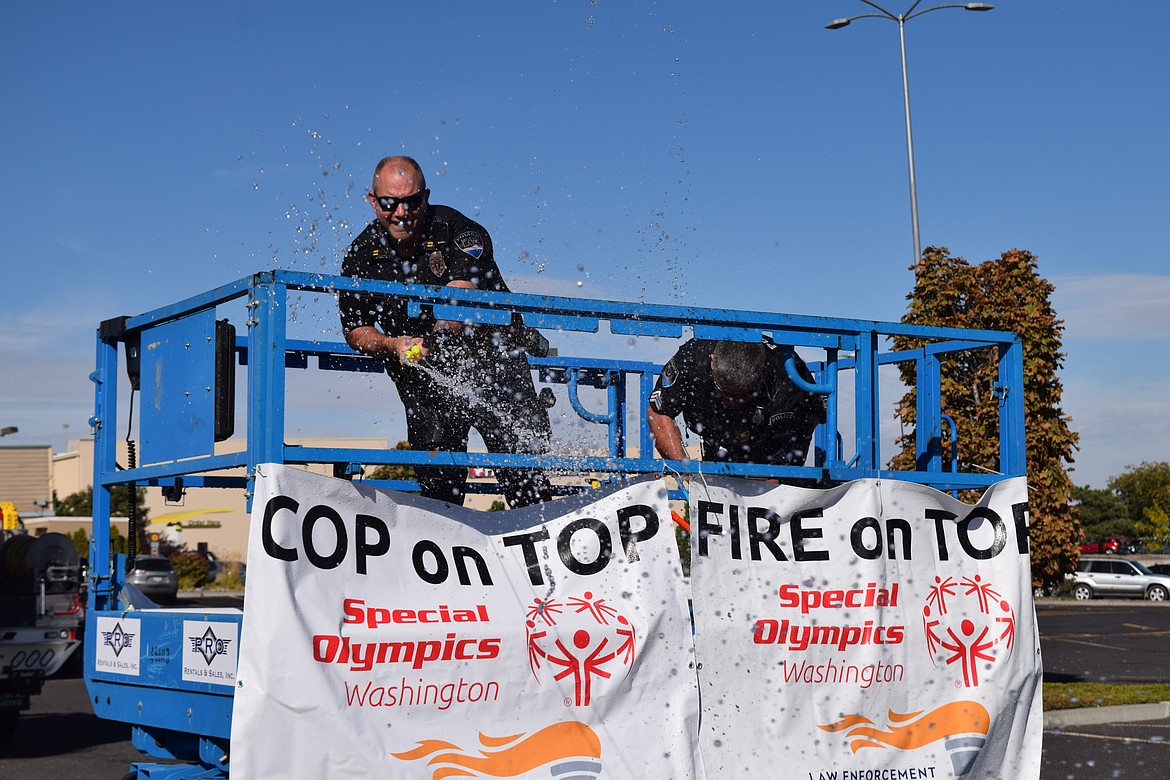 Moses Lake Police Department Capt. Mike Williams lets loose with both barrels during a Special Olympics fundraiser in Moses Lake on Friday.