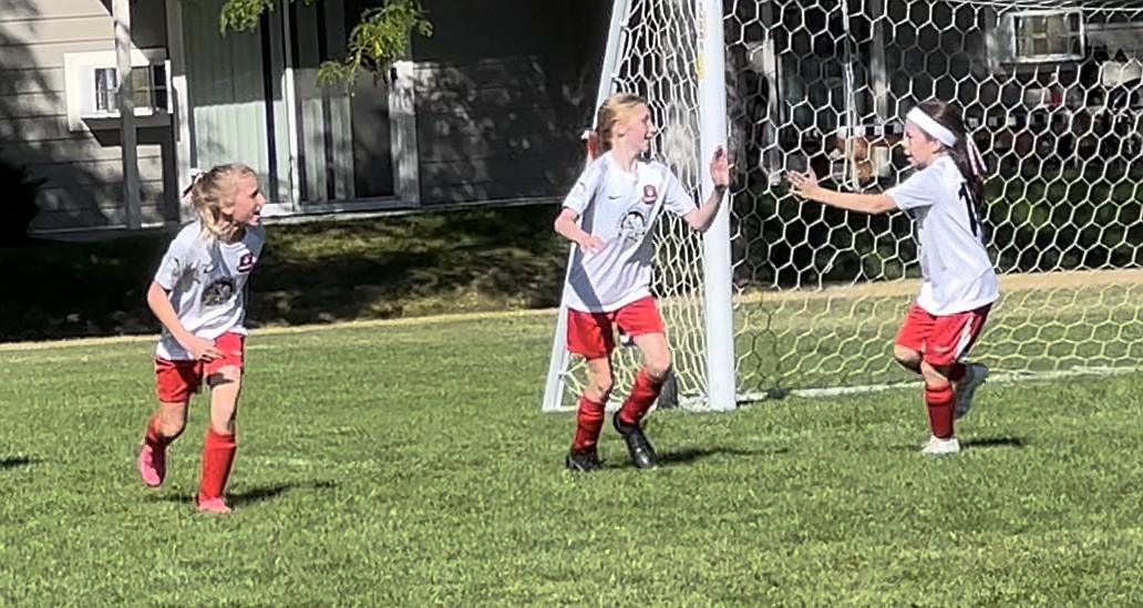 Photo by JULIE SPEELMAN
The Thorns FC 11 girls soccer team tied the Cheney Storm FC 2-2 on Saturday, on goals by Piper Hardwood and Hailey Viaud. Above, Parvati Palmgren, left, and Vitorie James congratulate Piper Hardwood, center, on her goal.