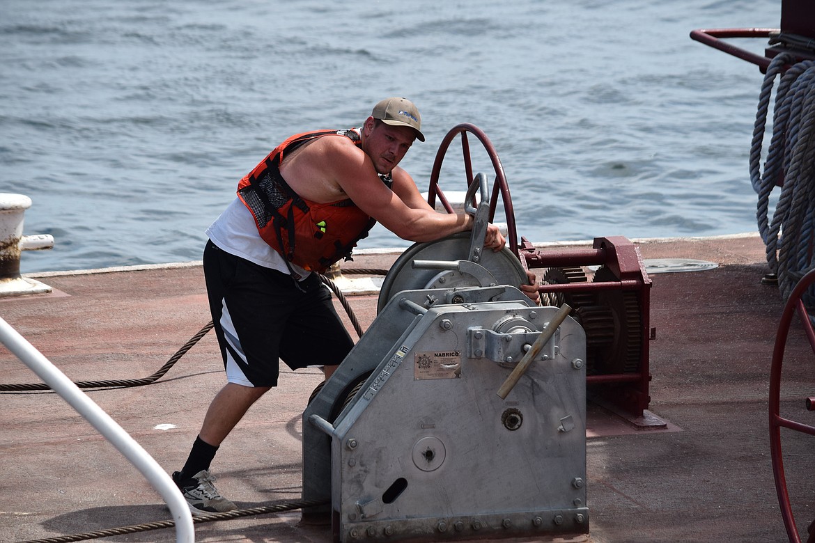 Deckhand Sean Malloy uses a winch to tighten 1.5-inch steel cable in place to secure barges to each other. Despite wind and some rough river conditions, none of the cables or ropes worked loose and the entire tow was very stable during the four-day trip downriver in early August.