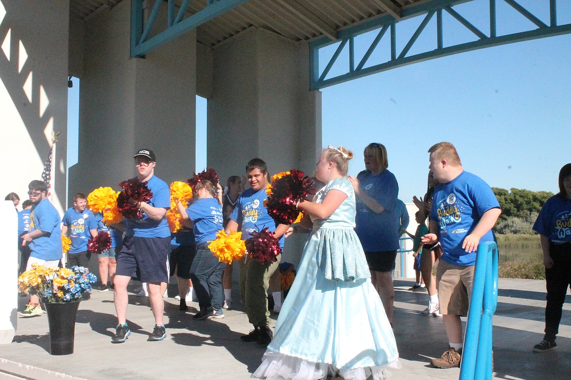 People with Down syndrome have fun dancing on stage at the Centennial Amphitheater in Moses Lake before setting out on the annual Buddy Walk Saturday.