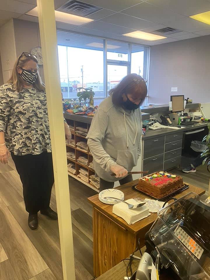 Patti Trujillo cuts the cake during her birthday party at the office earlier this year just prior to pandemic restrictions being lightened. Patti kept her coworkers smiling and laughing through years of challenges and acted as a bright spot in the lives of those around her.