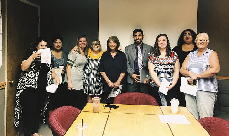 Patti Trujillo, center in black, poses for a photo with current and former staff at the Columbia Basin Herald. Patti saw multiple generations of sales professionals come through the Herald's office on Third Street in Moses Lake and she will be dearly missed by those who knew her.