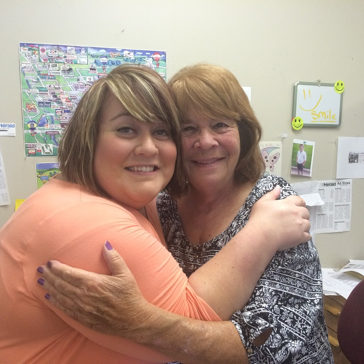 Patti Trujillo, right, shares a smile and a hug with Emily Duvall at the Columbia Basin Herald office in July 2015.