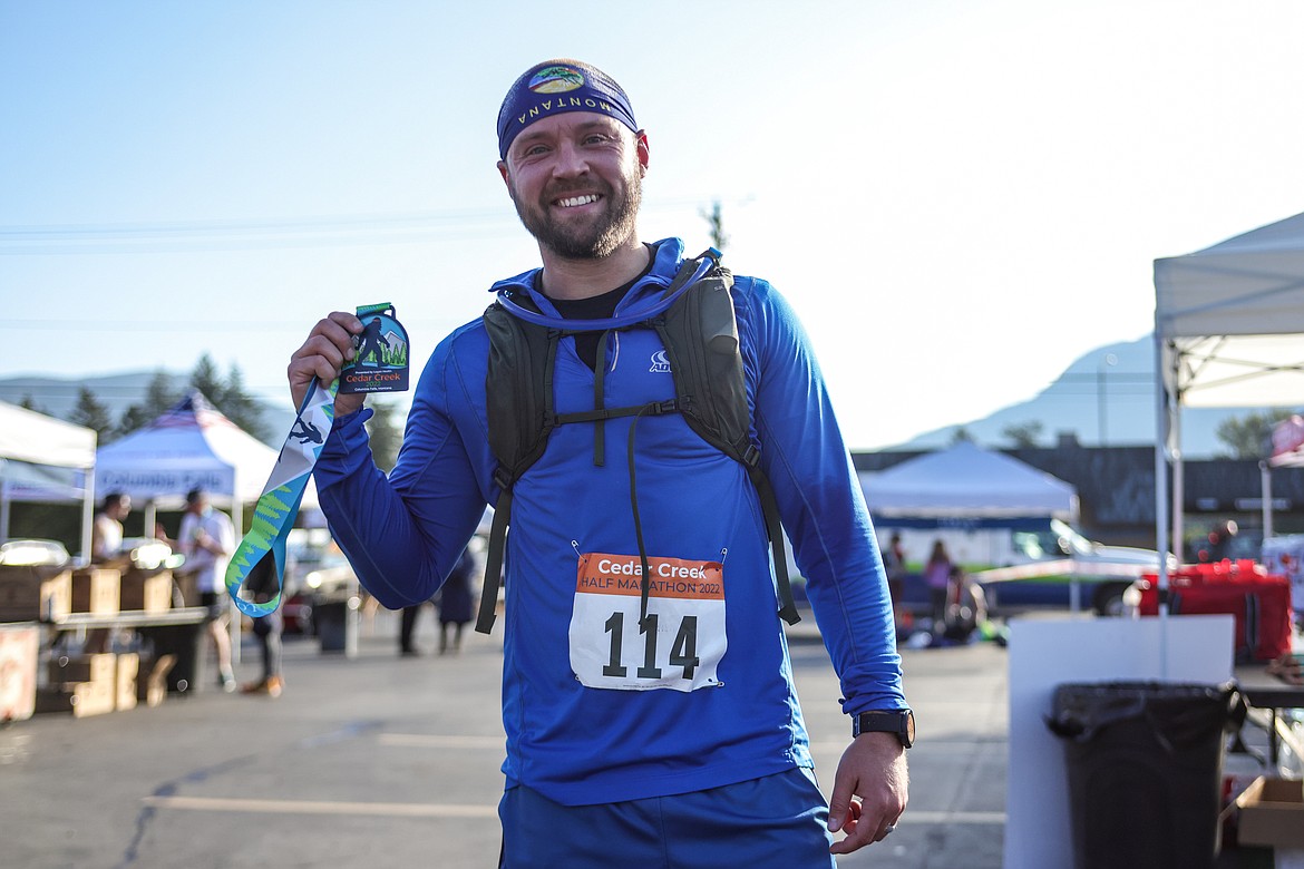 Cormac Moore of Columbia Falls celebrates at the finish line of the Cedar Creek Marathon. (JP Edge photo)