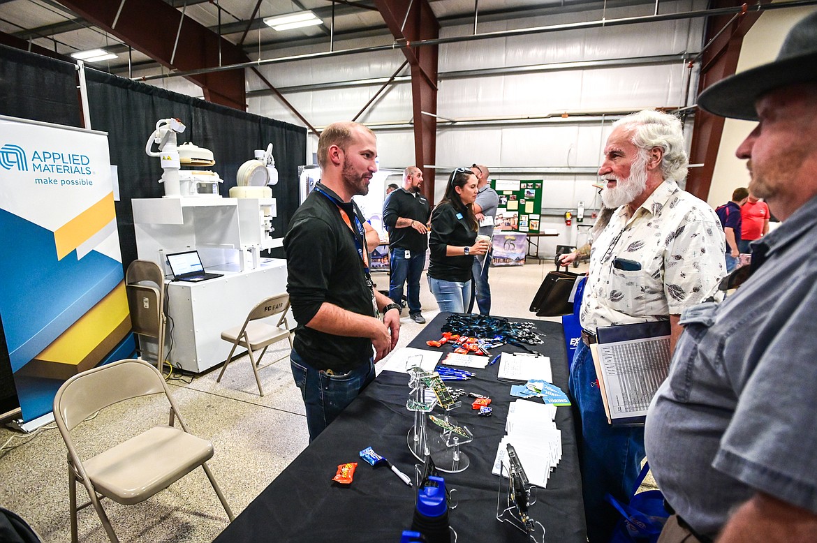 The team from Applied Materials speaks with attendees at the 2022 Job & Veteran Opportunity Fair at the Flathead County Fairgrounds Expo Building on Wednesday, Sept. 28. (Casey Kreider/Daily Inter Lake)