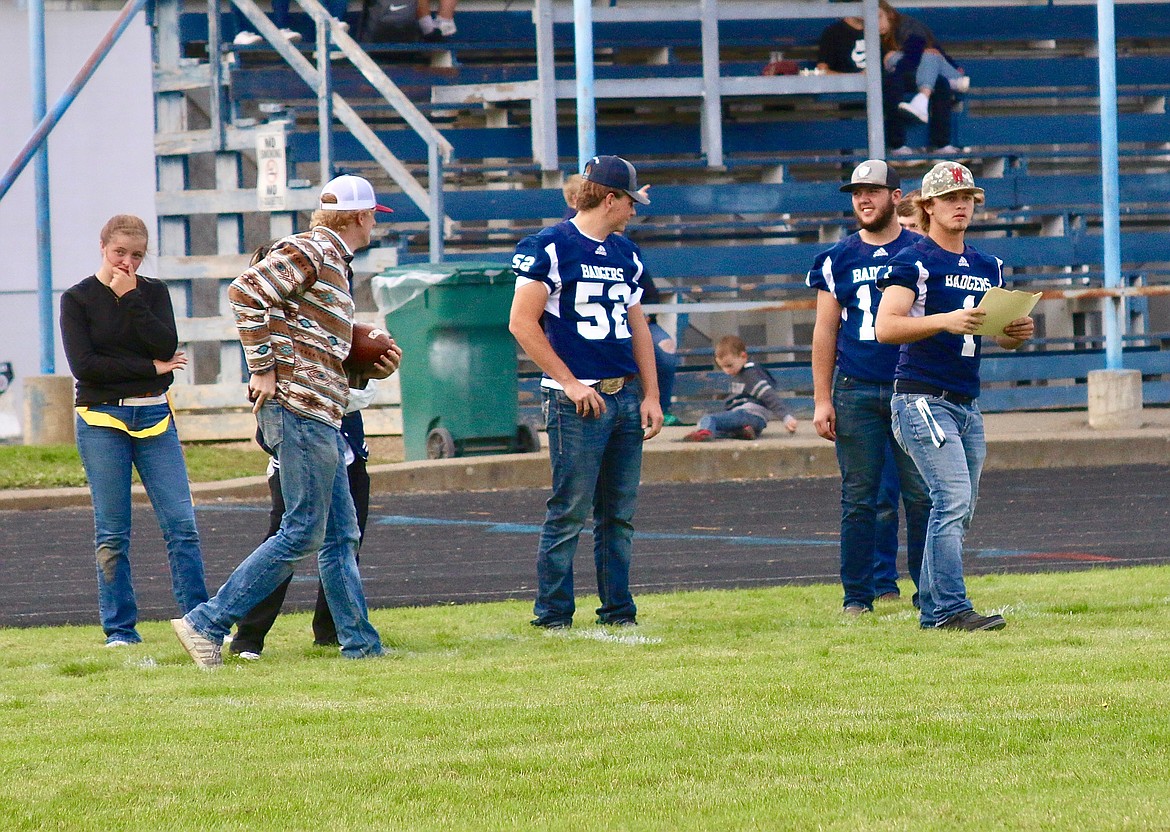 Senior football players coach from the sidelines at the powder puff football game. From left: Trew Lammers, Henry Willis, Dillion Mai, Michael Bollsweiler and Teigan Banning.