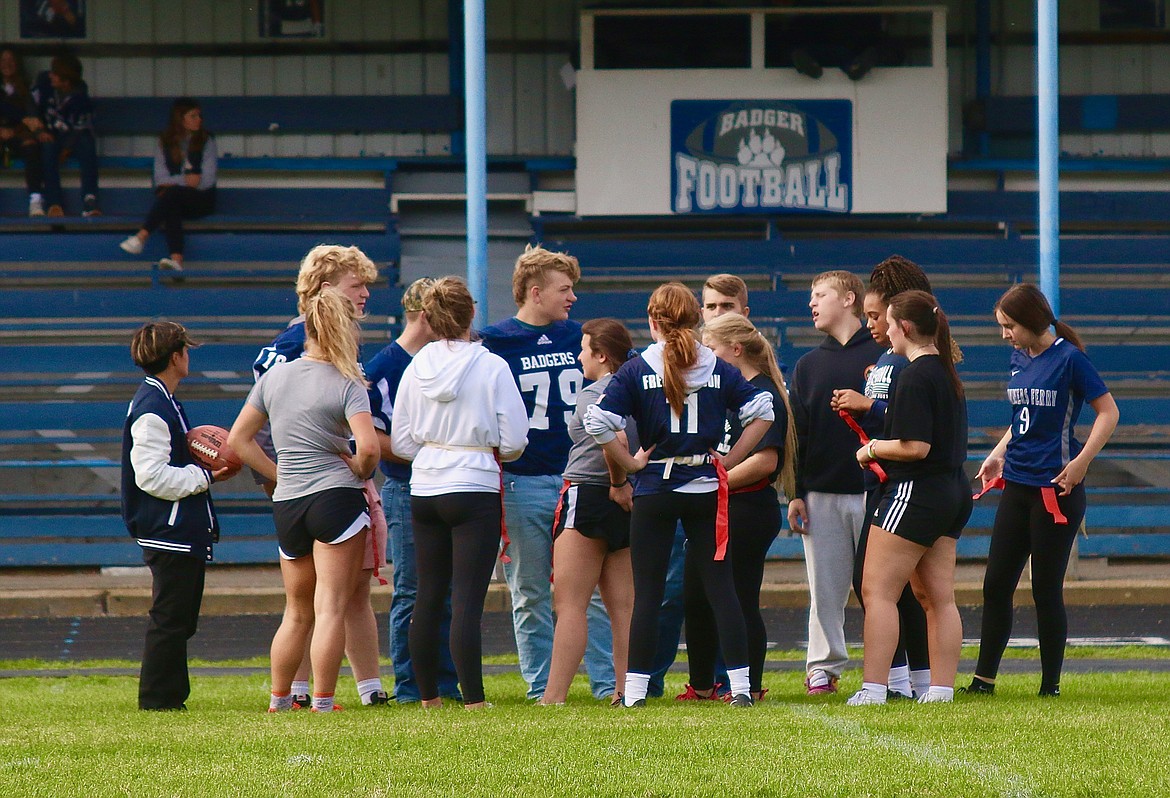 Juniors strategize at powder puff football.