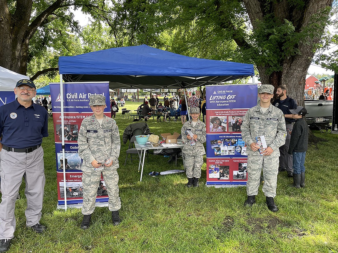 Members of the Bonners Ferry flight of the Civil Air Patrol stand at attention at their recruiting booth at the fairgrounds during the 4th of July celebration.  Pictured, from left are Maj. K. Kamiab, Cadet First Class R. Law, Cadet First Class T. Law. and Cadet First Class W. Blackmore.