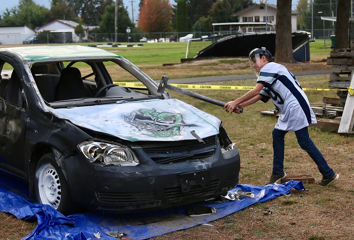 Badger supporter participating in the car smash at the Homecoming game.