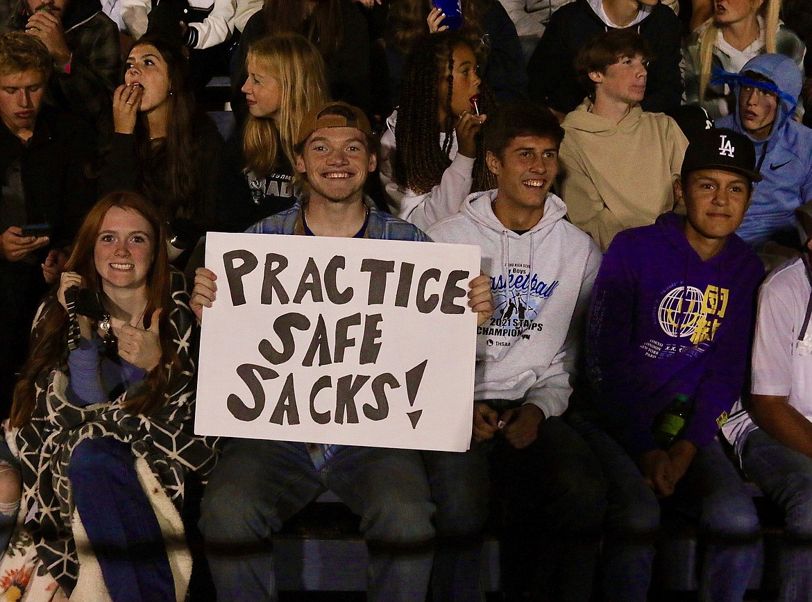 Badger fans show their support in the stands. Porter Schulte holds one of his many homemade signs.