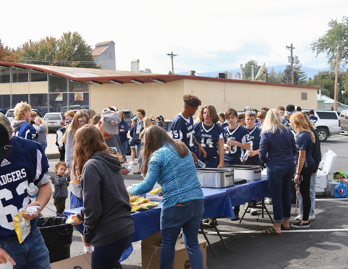 Hungry football players and community members come out to the Homecoming game tailgate at Mountain West Bank.