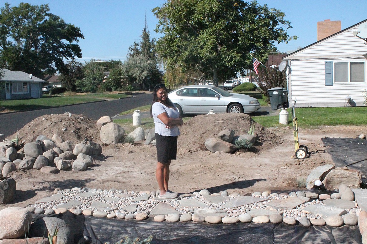 Teresa Fields stands in the yard of the Moses Lake home where she’s currently converting the lawn to a rock garden. Her plan is to use rocks to create a space that conserves water while highlighting plants mixed in among the stone landscaping.