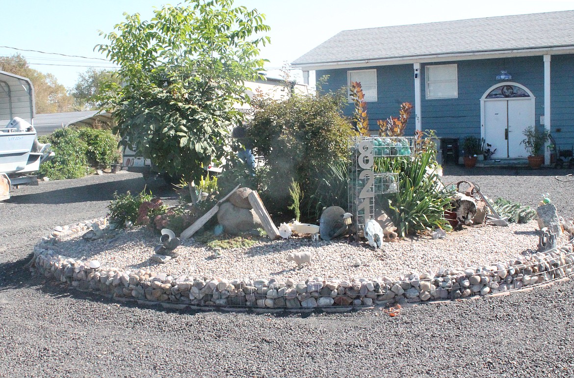 In front of Teresa Fields’ home she has a large round rockery with a variety of decorations, including a large F made from gambion and filled with Japanese glass fishing floats.