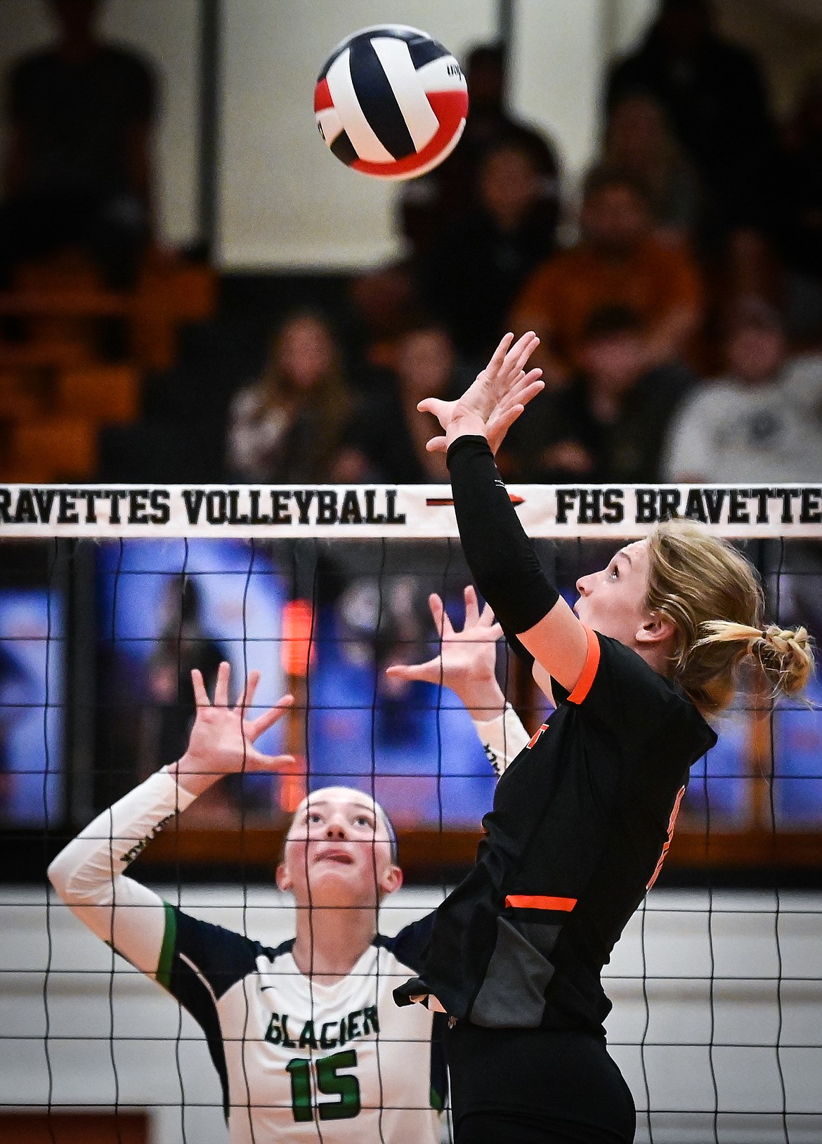 Flathead's Georgia Wilson (11) passes to a teammate at the net in front of Glacier's Ella Farrell (15) during crosstown volleyball at Flathead High School on Thursday, Sept. 29. (Casey Kreider/Daily Inter Lake)