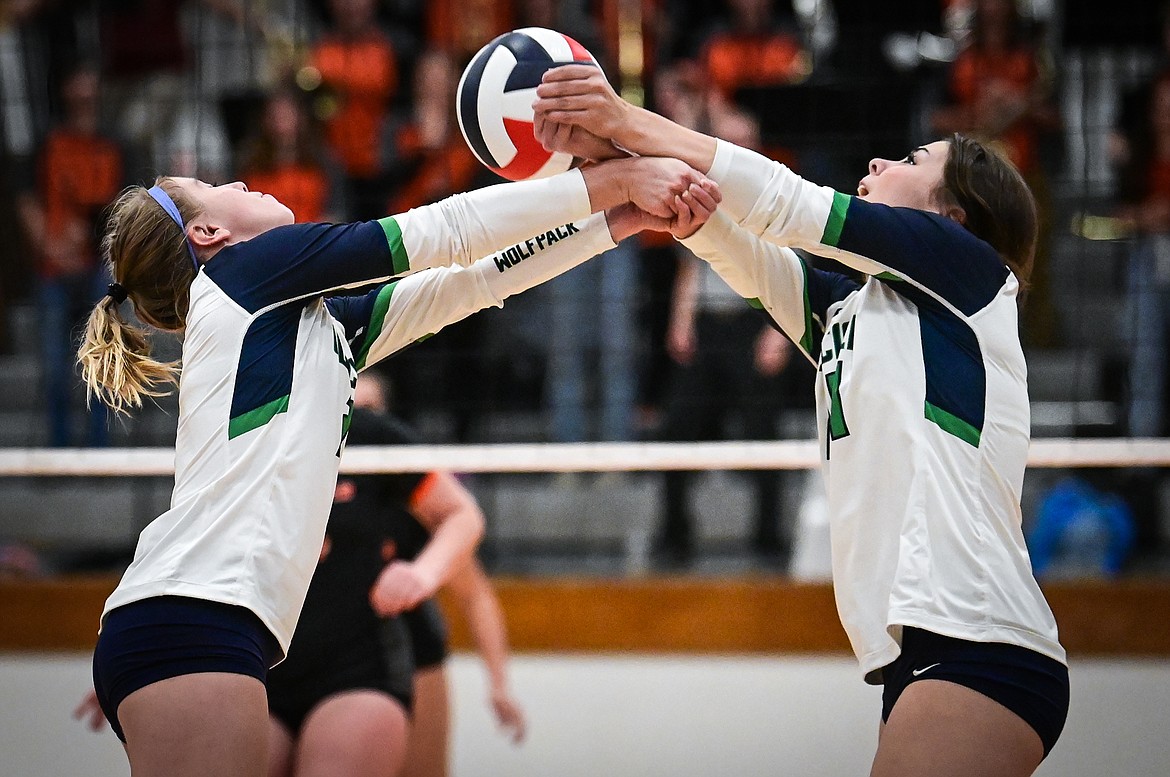 Glacier's Kaylie Field (2) and Natalie Herne (24) bump a ball over the net against Flathead during crosstown volleyball at Flathead High School on Thursday, Sept. 29. (Casey Kreider/Daily Inter Lake)