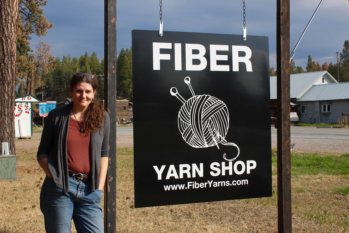 Fiber owner Cindy Ruprecht stands in front of her sign by Montana 35. (Taylor Inman/Bigfork Eagle)