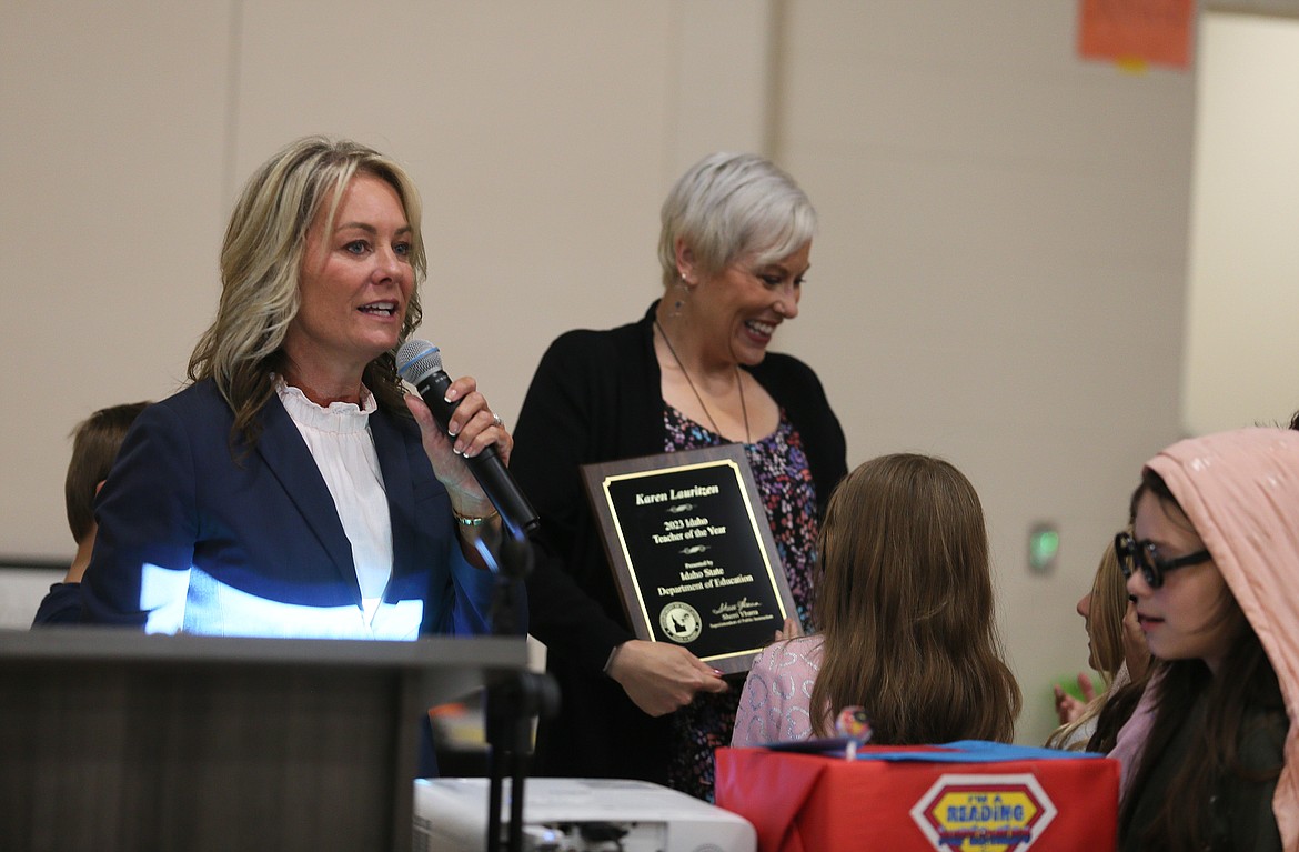 Karen Lauritzen, 2023 Idaho Teacher of the Year, laughs with students as Superintendent of Public Instruction Sherri Ybarra speaks to the crowd Thursday morning at Treaty Rock Elementary School in Post Falls.