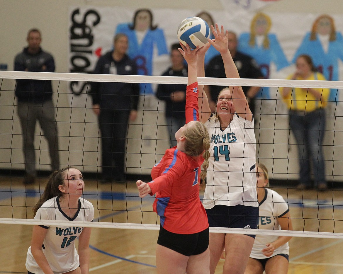 MARK NELKE/Press
Emberlyn Reynolds (14) of Lake City attempts to block the tip of Bailey Jaworski of Coeur d'Alene on Thursday night at Coeur d'Alene High.