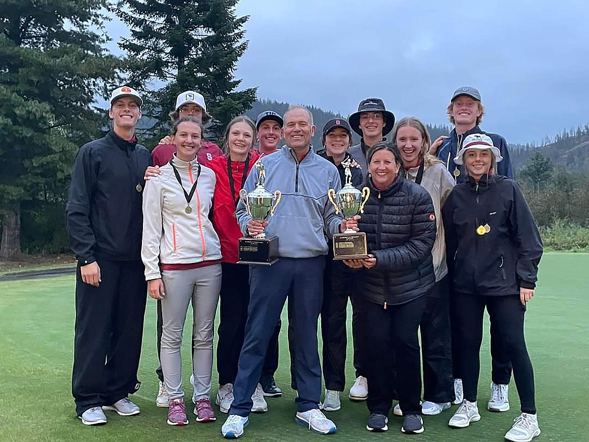 Sandpoint High School's golf teams pose with their trophies after both Bulldog team won districts at The Idaho Club on Thursday.