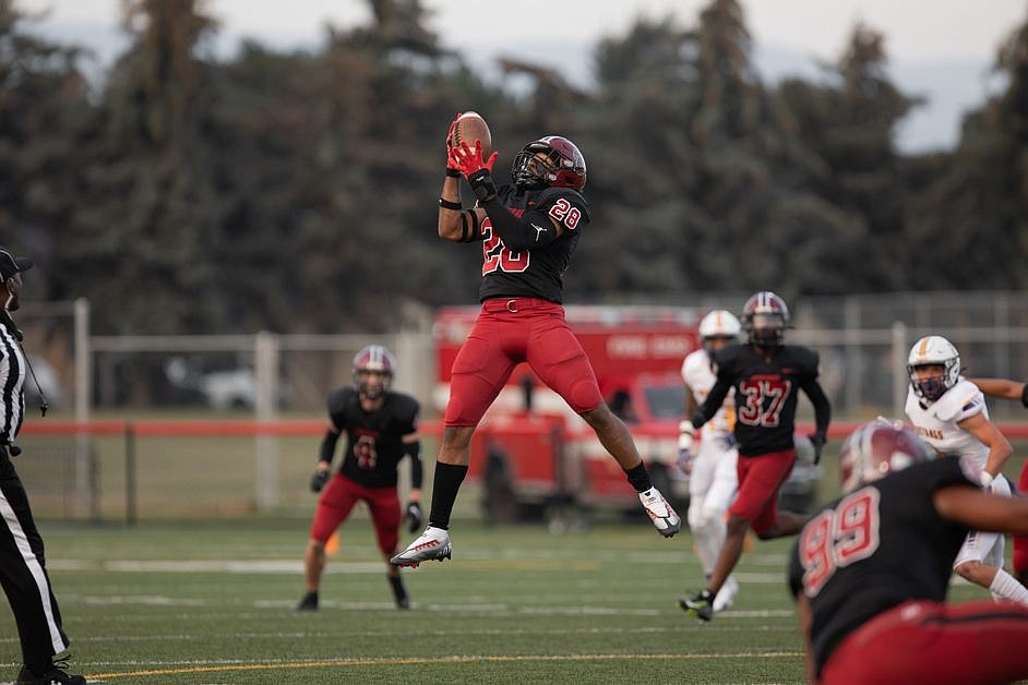 CWU linebacker Daeon Hudson leaps in the air for an interception in CWU’s matchup against Western New Mexico.