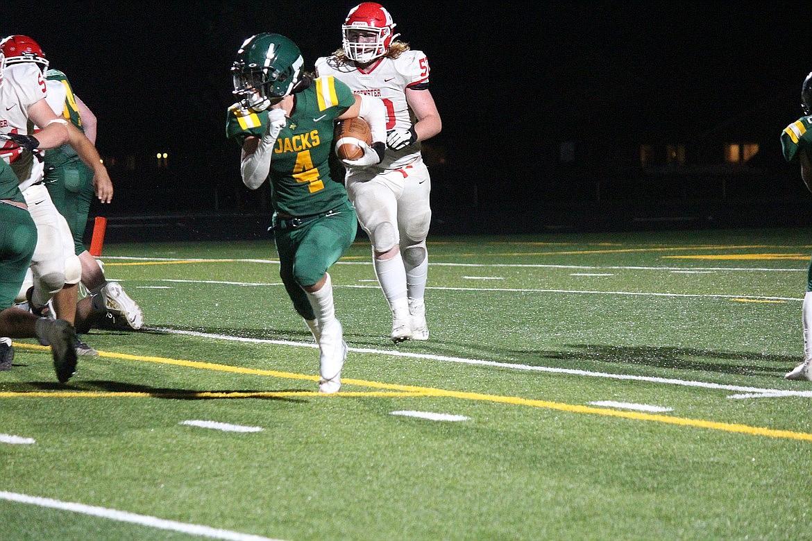 Quincy running back Jackson Yeates carries the ball past Brewster defenders during the Jackrabbits’ 34-6 win over the Bears last Friday.