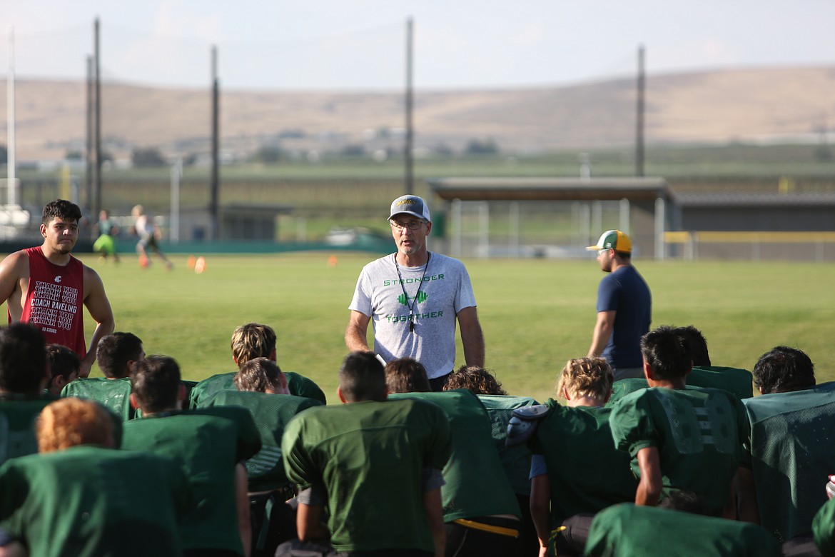 Quincy head coach Russ Elliott breaks down the team during the end of a practice during training camp. Elliott said that there is an importance in running efficient practices to prepare for games.