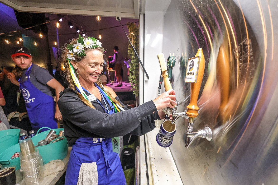 Teckla Putnam fills a stein at the Great Northwest Oktoberfest on Thursday in Whitefish. (JP Edge photo)