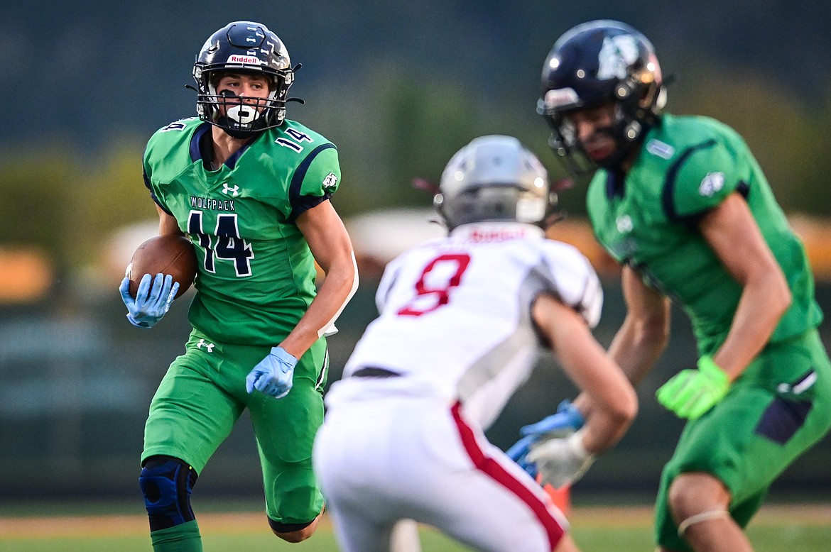 Glacier wide receiver Kaid Buls (14) picks up yardage after a reception in the first quarter against Helena at Legends Stadium on Friday, Sept. 30. (Casey Kreider/Daily Inter Lake)