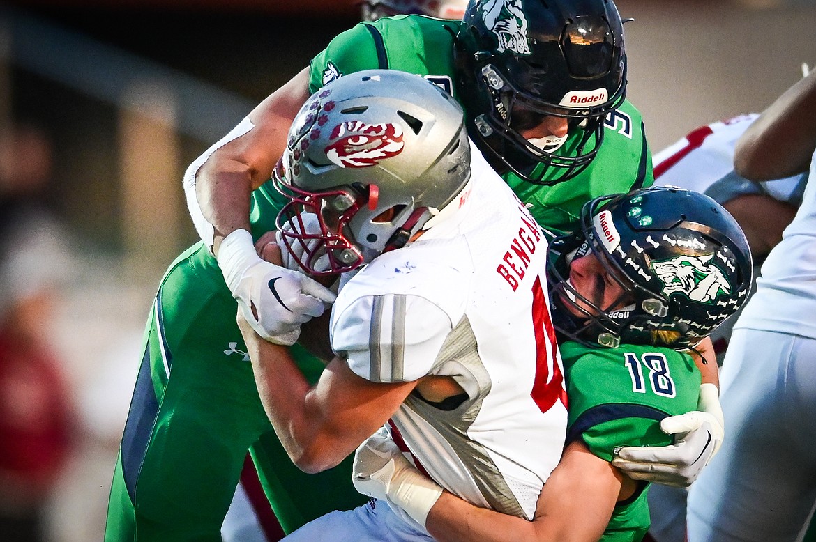 Glacier defenders Isaac Keim (9) and Easton Kauffman (18) bring down Helena's Kyler Larson (4) in the first quarter at Legends Stadium on Friday, Sept. 30. (Casey Kreider/Daily Inter Lake)