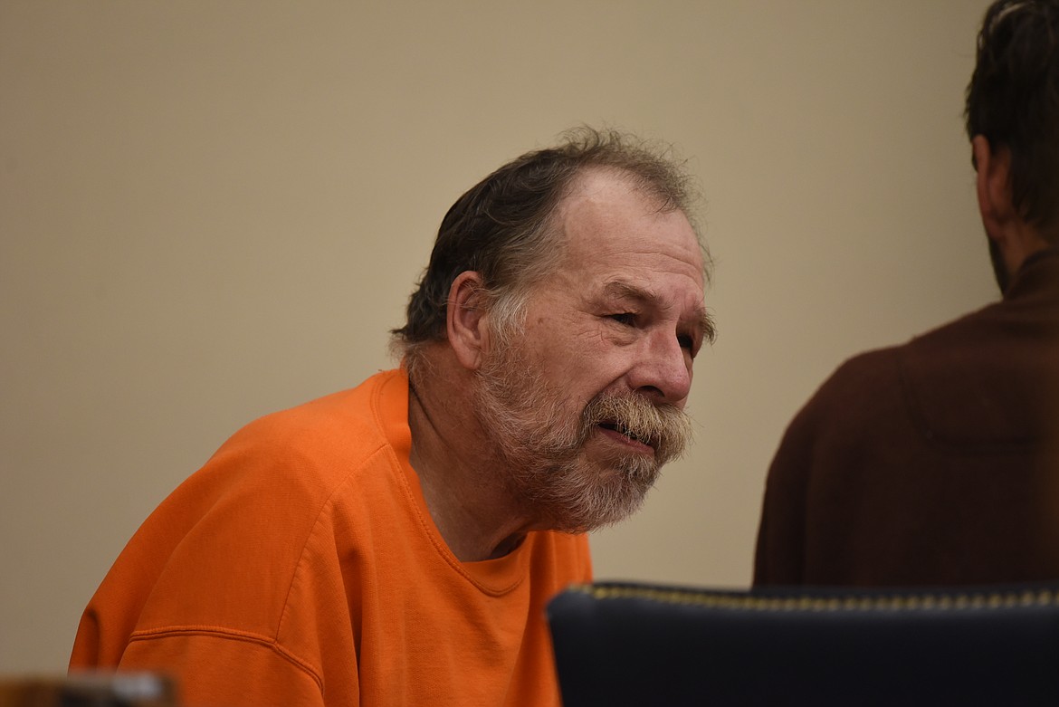 Raymond Irwin Hallas speaks with his attorney during his Sept. 29 arraignment on an assault with a weapon charge in Flathead County District Court. (Derrick Perkins/Daily Inter Lake)