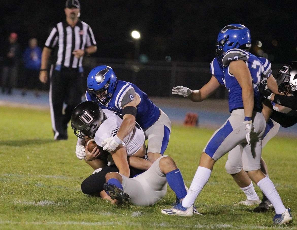 JASON ELLIOTT/Press
Coeur d'Alene senior linebacker Brandon Whitby brings down Union wide receiver Chase Lofton during the third quarter of Friday's game at Viking Field.