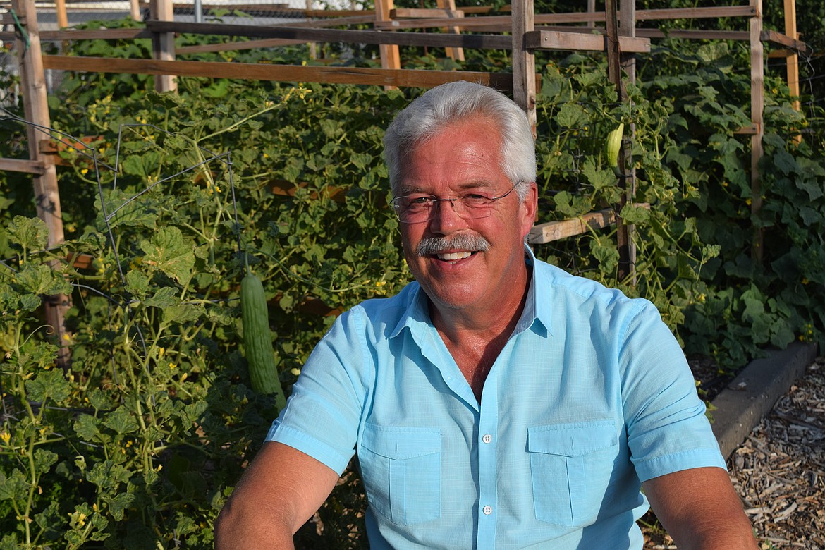 Don Key, a math teacher at Columbia Basin Job Corps, crouches in the vacant lot next to his Moses Lake home that he has turned into a garden. Key donated much of the fresh produce he grows to the Moses Lake Food Bank.