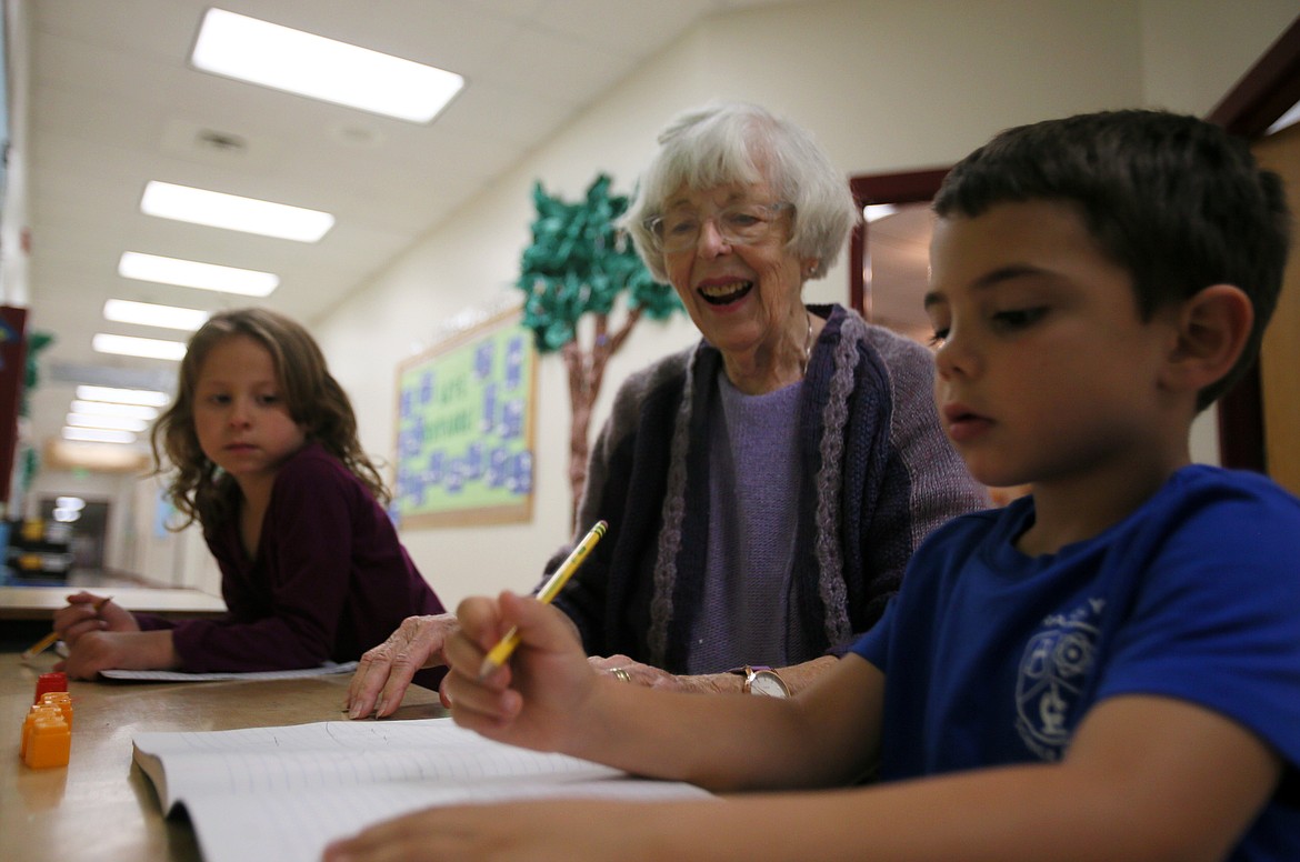 Retired teacher "Miss Janet" Crane, 89, helps first-graders Thomas Ely and Emma Worden with math problems on Thursday at Ramsey Magnet School of Science, where she has volunteered for 17 years.