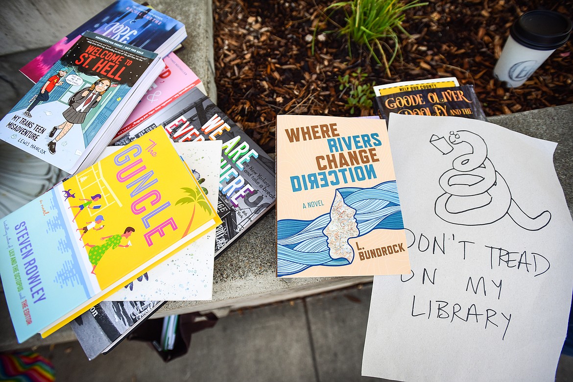 Several books, some by local authors, that highlight queer and social justice issues at a read-in outside ImagineIF Library in Kalispell on Saturday, Oct. 1. (Casey Kreider/Daily Inter Lake)