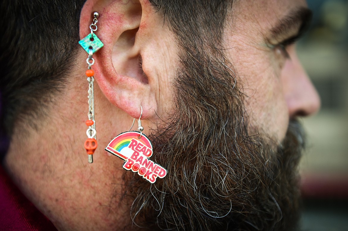 Bryan Bebb, executive director with Glacier Queer Alliance, wears an earring that says "Read Banned Books" during a read-in to highlight censorship issues and promote recently-challenged books outside ImagineIF Library in Kalispell on Saturday, Oct. 1. (Casey Kreider/Daily Inter Lake)