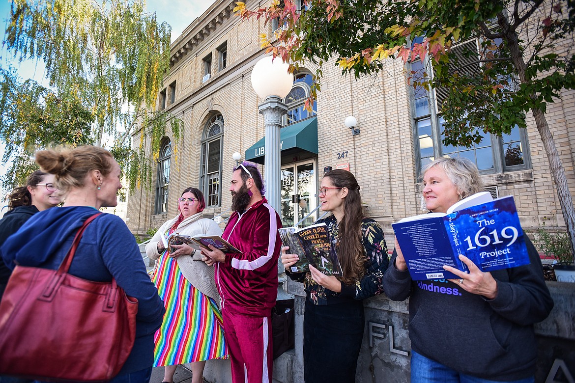 Supporters of the public library system and Love Lives Here in the Flathead Valley hold a read-in to highlight censorship issues and promote recently-challenged books outside ImagineIF Library in Kalispell on Saturday, Oct. 1. (Casey Kreider/Daily Inter Lake)