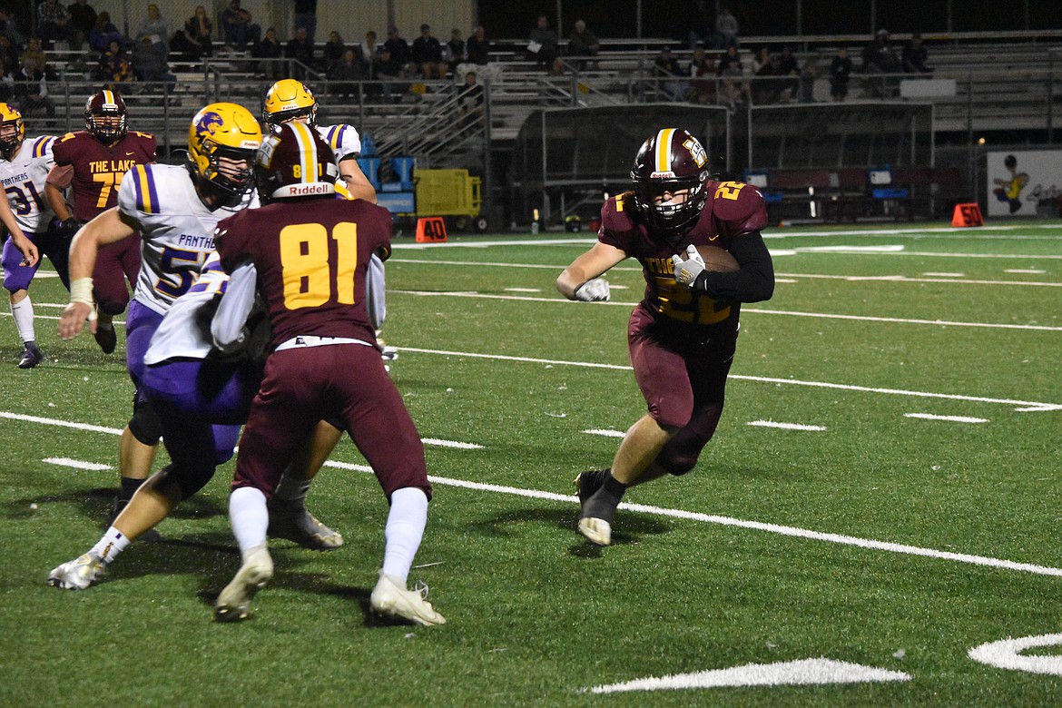 Maverick junior Jonah Robertson (22) rushes as sophomore Isaiah Jackson-Moreno (81) holds a couple Wenatchee players back and creates an opening for Robertson.