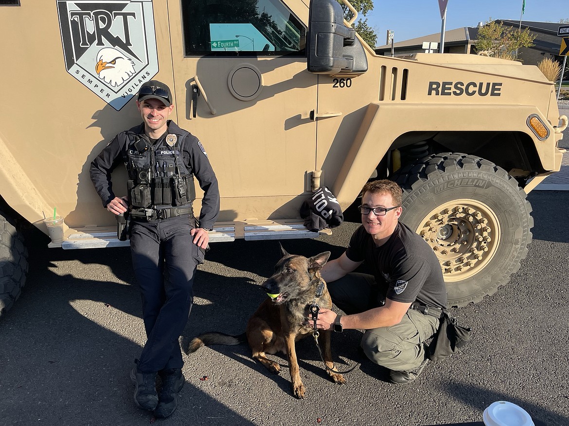 Moses Lake Police Department officers Chase Pitt and Brad Zook with K9 Rex at the Cops, Cars and Coffee gathering on Saturday morning. The gathering was a fundraiser for the BlueBridge program, which provides MLPD officers with prepaid credit cards to help people in need.