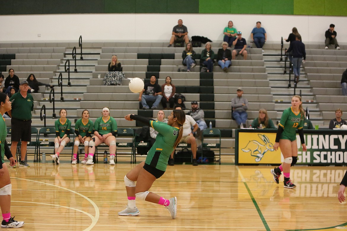 Quincy freshman Alyana Quintanilla passes the ball over the net during the first set on Saturday.