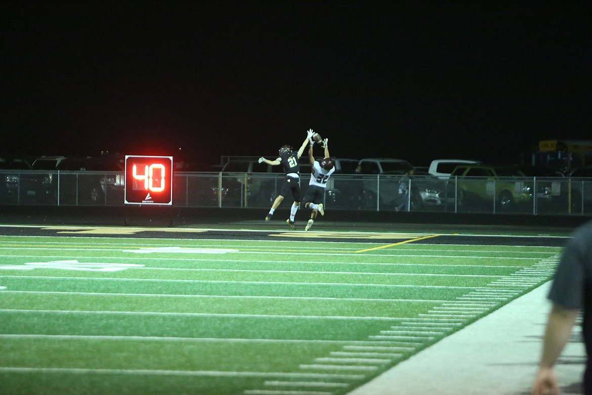 Royal defensive back Jackson Larsen (21) breaks up a pass intended for Wahluke running back Anthony Zebrano.