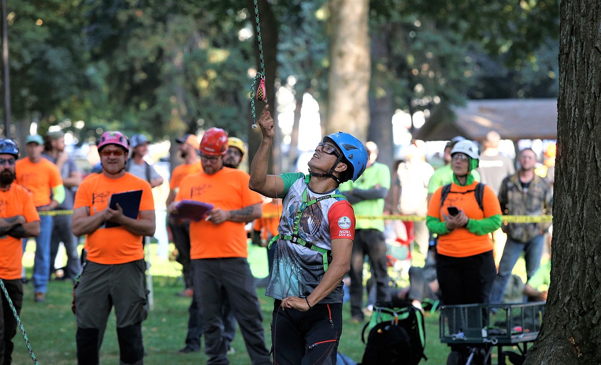 Noel Rodriguez checks his rope before climbing in Saturday's Pacific Northwest International Society of Arboriculture’s annual Tree Climbing Championship at City Park.